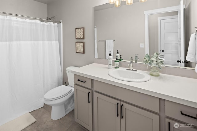 bathroom featuring vanity, toilet, and tile patterned floors