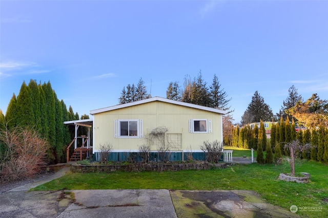 view of side of home featuring a lawn