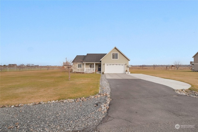 view of front facade with a rural view, a front lawn, and a garage