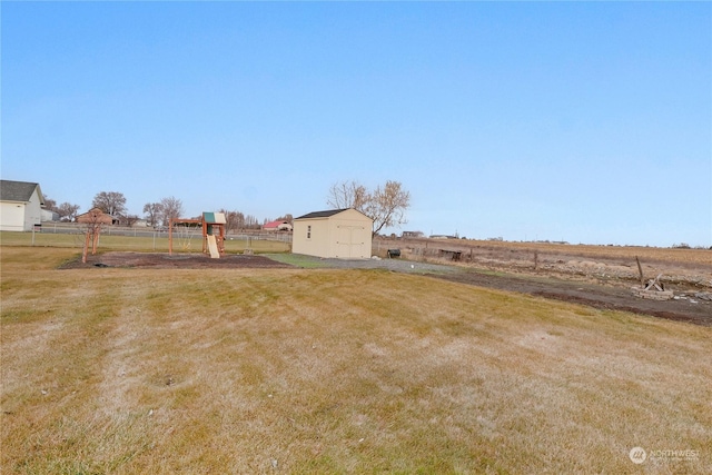 view of yard with a rural view and a storage unit