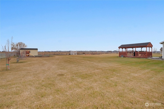 view of yard featuring a rural view and a gazebo