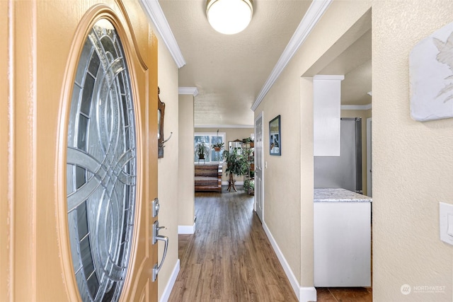 hall with wood-type flooring and ornamental molding