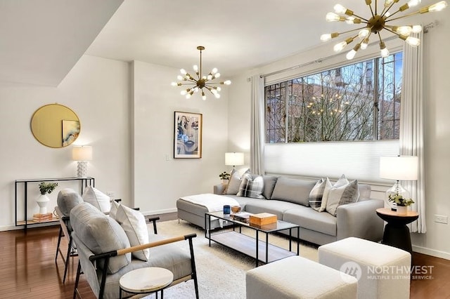 living room featuring a notable chandelier and dark hardwood / wood-style floors