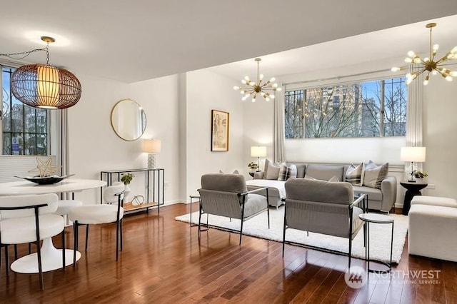 living room with dark wood-type flooring and a chandelier