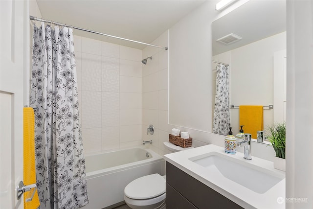 full bathroom featuring shower / bath combo, toilet, and vanity