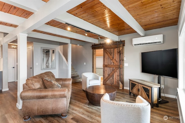 living room with track lighting, a barn door, a wall unit AC, wood ceiling, and beam ceiling