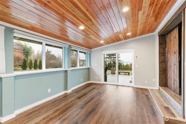 empty room with lofted ceiling, wood-type flooring, ornamental molding, and wood ceiling