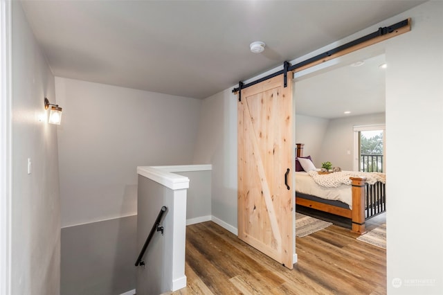 interior space featuring a barn door and wood-type flooring