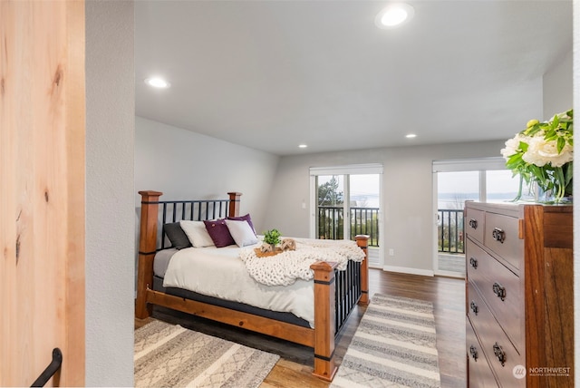 bedroom with wood-type flooring and access to exterior