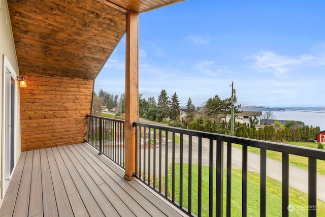 wooden terrace featuring a water view