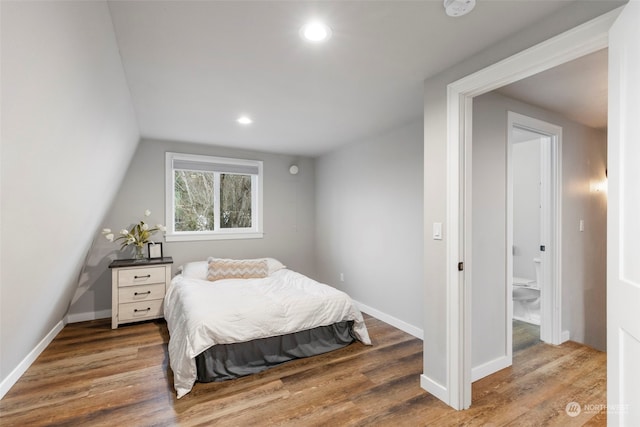 bedroom featuring vaulted ceiling and dark hardwood / wood-style floors