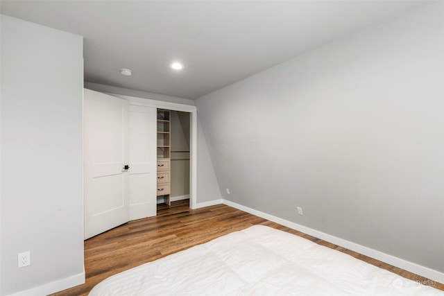 bedroom with hardwood / wood-style flooring and a closet