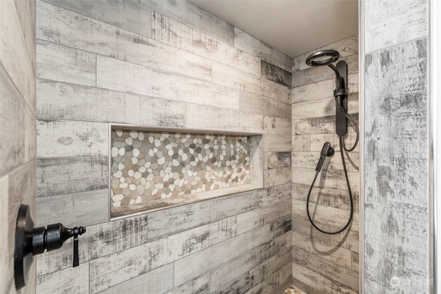 details featuring tiled shower and wooden walls