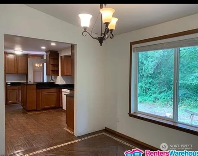 kitchen featuring an inviting chandelier, dishwasher, dark parquet floors, and pendant lighting