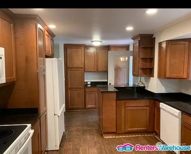 kitchen featuring white appliances and dark hardwood / wood-style floors