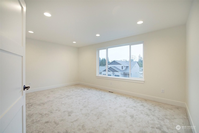 spare room with light colored carpet