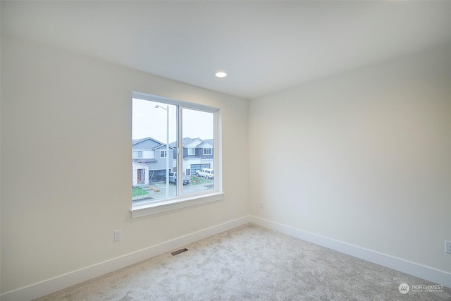 unfurnished room with light colored carpet