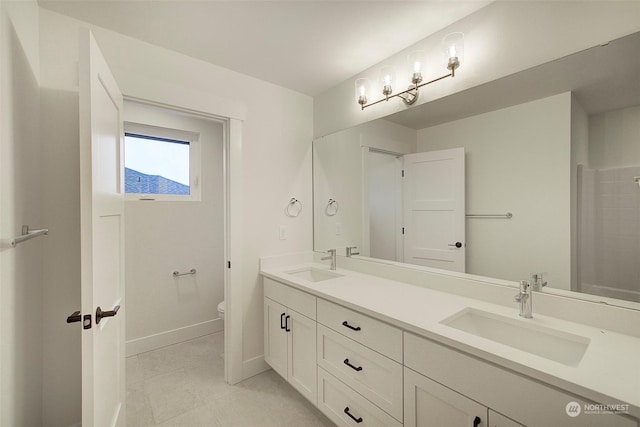 bathroom featuring toilet and vanity