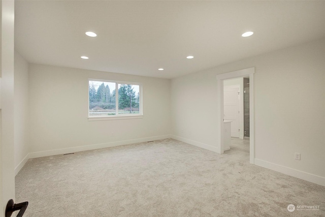 empty room featuring light carpet