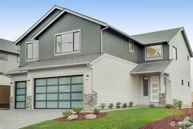 view of front of house with a garage and a front yard