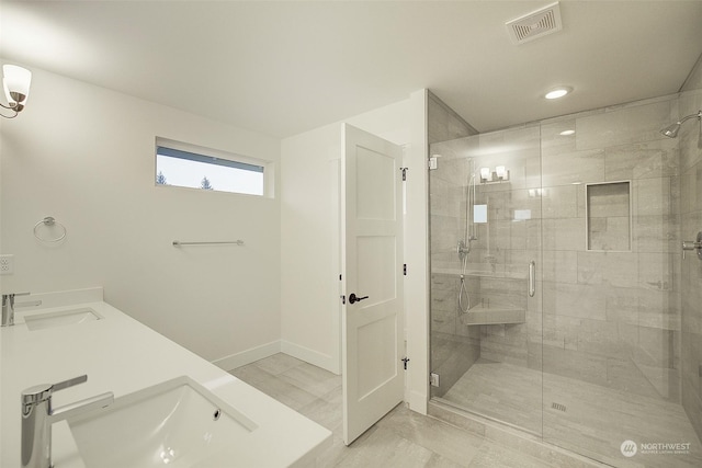 bathroom with an enclosed shower and sink