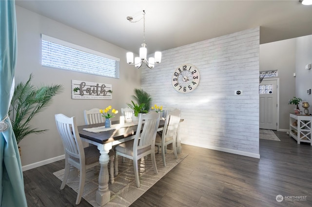 dining room with dark hardwood / wood-style flooring and a notable chandelier