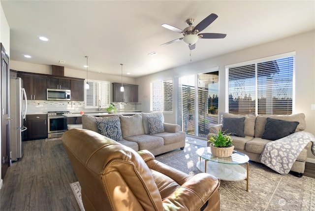 living room featuring ceiling fan and light hardwood / wood-style flooring