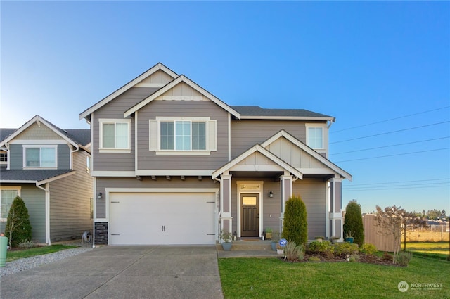 craftsman-style home featuring a garage and a front lawn