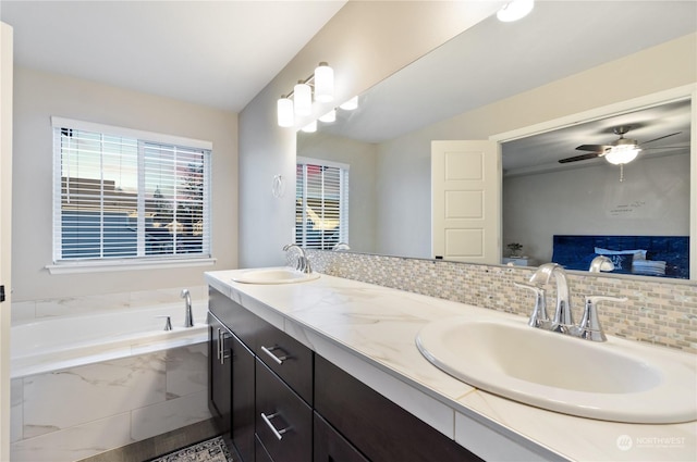 bathroom with tasteful backsplash, vanity, ceiling fan, and tiled tub