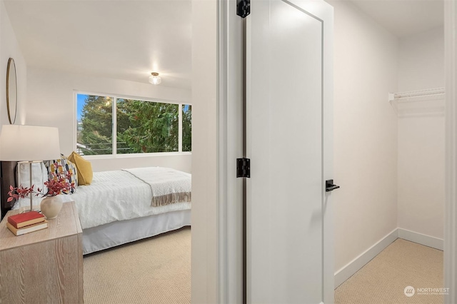 bedroom featuring light colored carpet