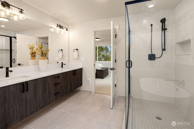 bathroom featuring tile patterned floors, an enclosed shower, and vanity