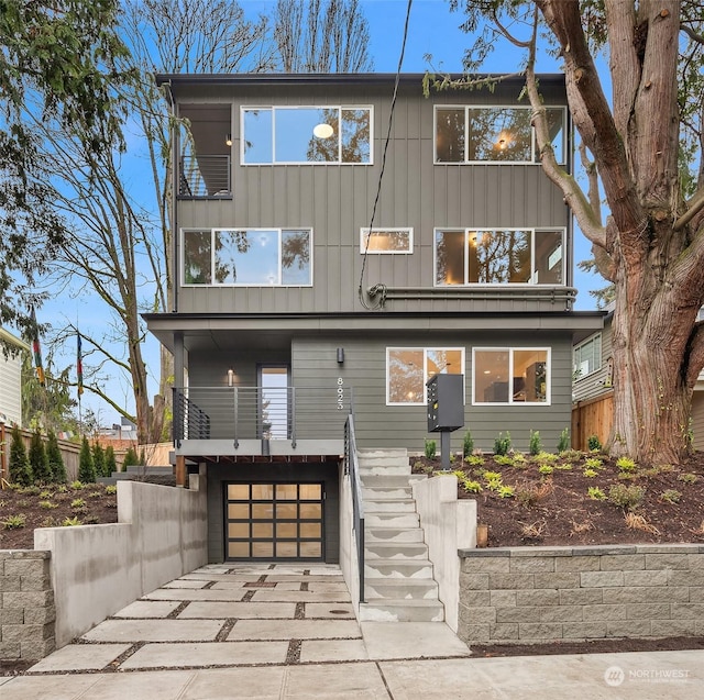 view of front of property featuring a balcony and a garage