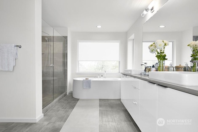 bathroom featuring vanity and shower with separate bathtub