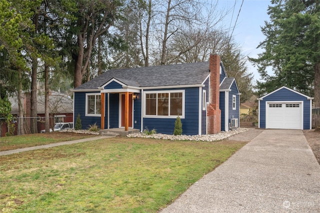 view of front facade with an outbuilding, a front yard, and a garage