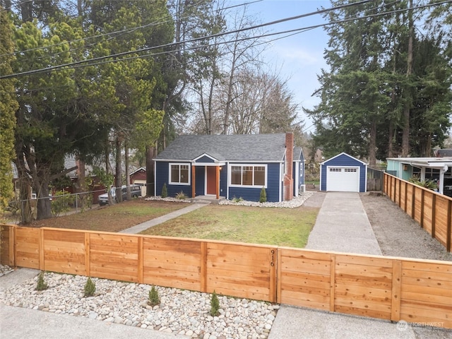 view of front of house featuring an outbuilding, a front yard, and a garage