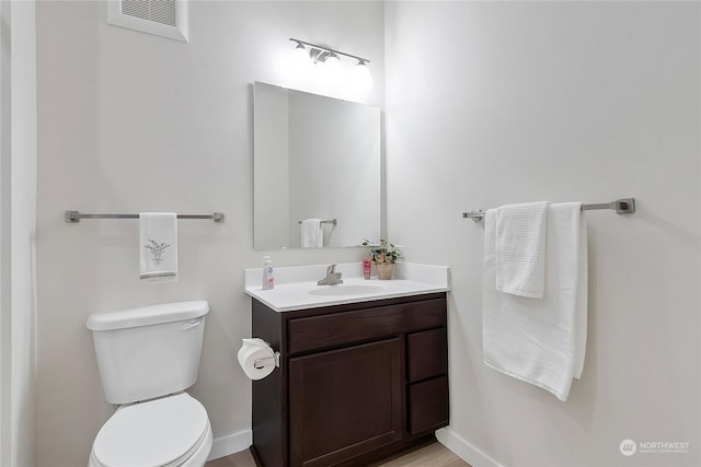 bathroom with toilet and vanity