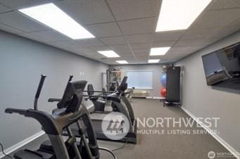 gym with a paneled ceiling