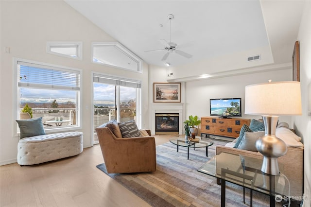 living room featuring ceiling fan, hardwood / wood-style floors, and high vaulted ceiling