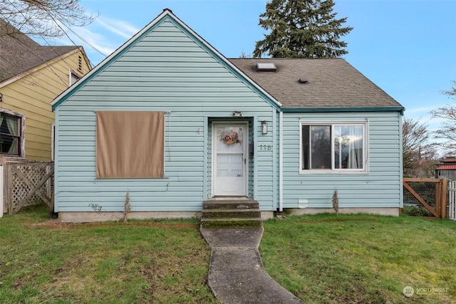 bungalow-style house featuring a front yard