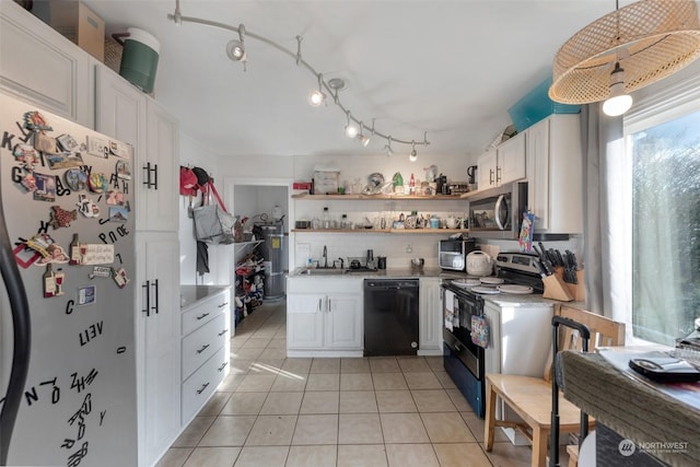 kitchen featuring backsplash, sink, light tile patterned flooring, white cabinetry, and appliances with stainless steel finishes