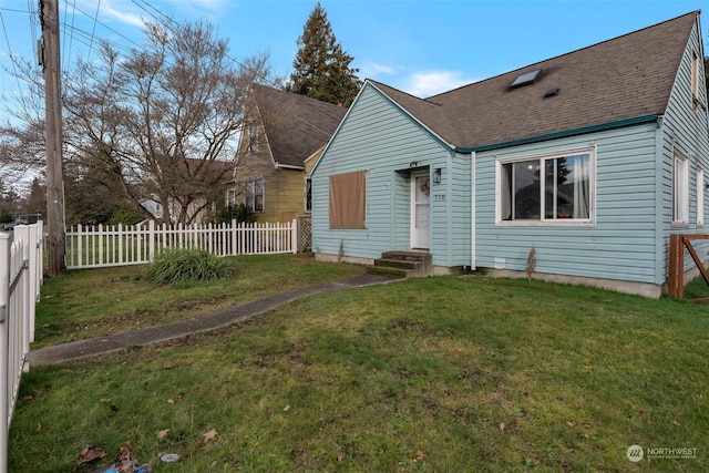 rear view of property with a yard