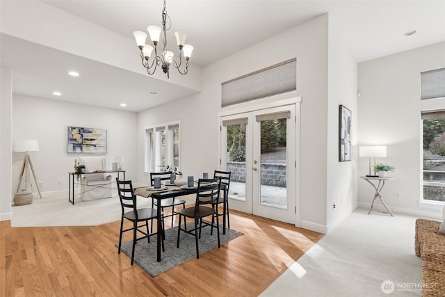 dining area featuring french doors, a notable chandelier, light wood finished floors, recessed lighting, and baseboards