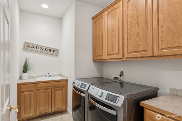 laundry room featuring washer and clothes dryer, a sink, cabinet space, and recessed lighting