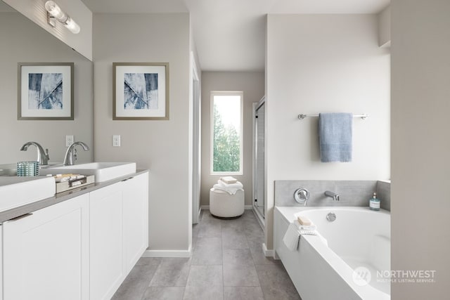 bathroom with plus walk in shower, vanity, and tile patterned flooring