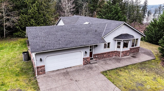 view of front facade with a front yard and a garage