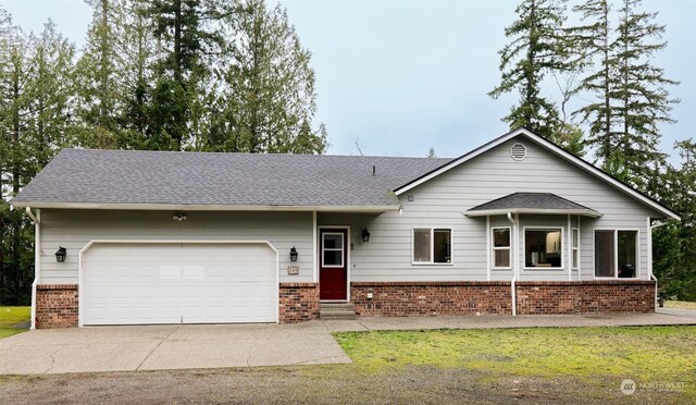 single story home featuring a front yard and a garage