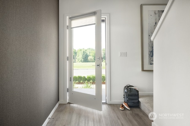 doorway with hardwood / wood-style flooring