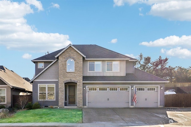 view of front of home with a garage and a front lawn