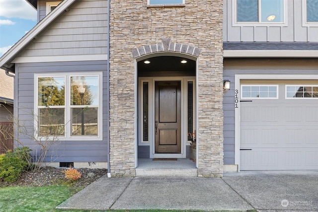 doorway to property with a garage