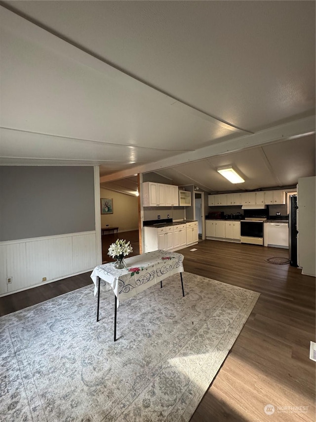 recreation room featuring vaulted ceiling and dark hardwood / wood-style flooring